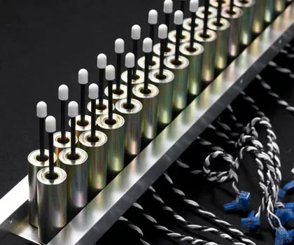 Row of QRS solenoids installed beneath piano keys